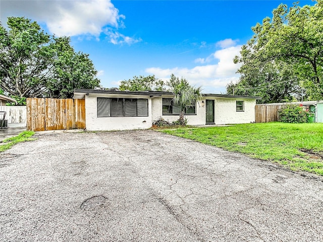 ranch-style house with a front lawn