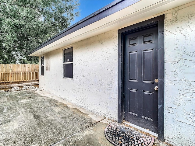 property entrance featuring a patio area