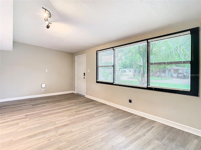 spare room featuring light hardwood / wood-style floors