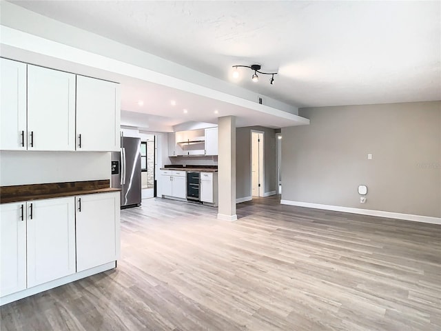 kitchen featuring stainless steel fridge with ice dispenser, light hardwood / wood-style flooring, white cabinets, and wine cooler