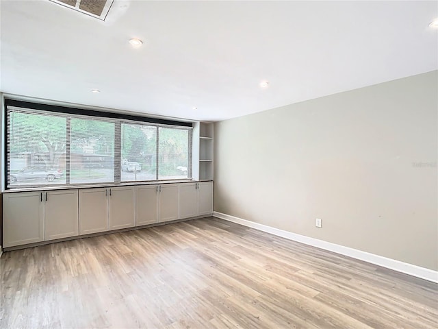 unfurnished room with light wood-type flooring