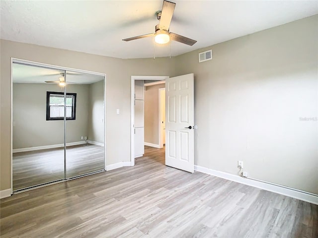 unfurnished bedroom featuring a closet, ceiling fan, and light hardwood / wood-style flooring