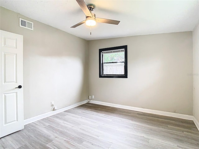 empty room with lofted ceiling, light hardwood / wood-style floors, and ceiling fan