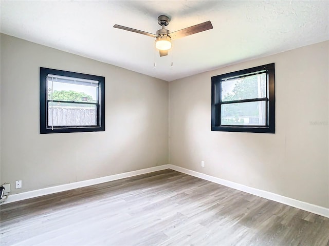 empty room featuring ceiling fan and hardwood / wood-style floors