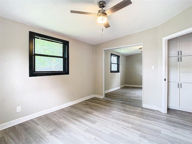 unfurnished bedroom with ceiling fan and light hardwood / wood-style floors