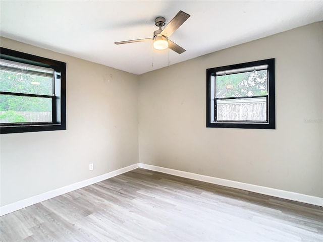 empty room featuring wood-type flooring and ceiling fan