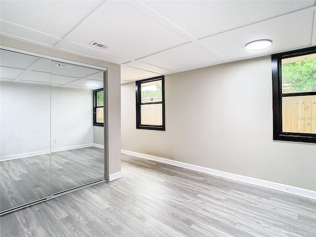 interior space featuring light hardwood / wood-style floors, a closet, and multiple windows