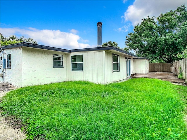 back of house with a yard