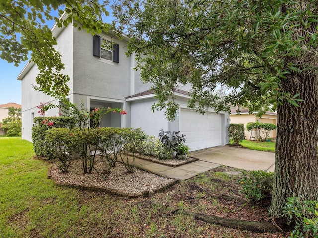 view of front of property featuring a garage and a front lawn