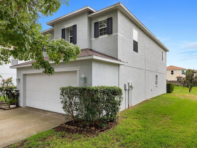 view of side of property with a yard and a garage