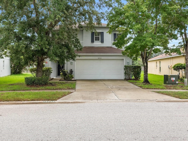 view of front of house with a garage and a front lawn