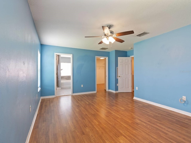 unfurnished room with wood-type flooring and ceiling fan