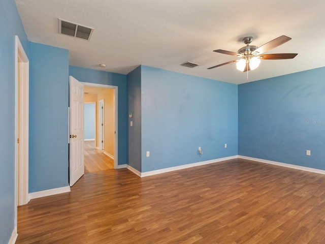 spare room featuring hardwood / wood-style flooring and ceiling fan