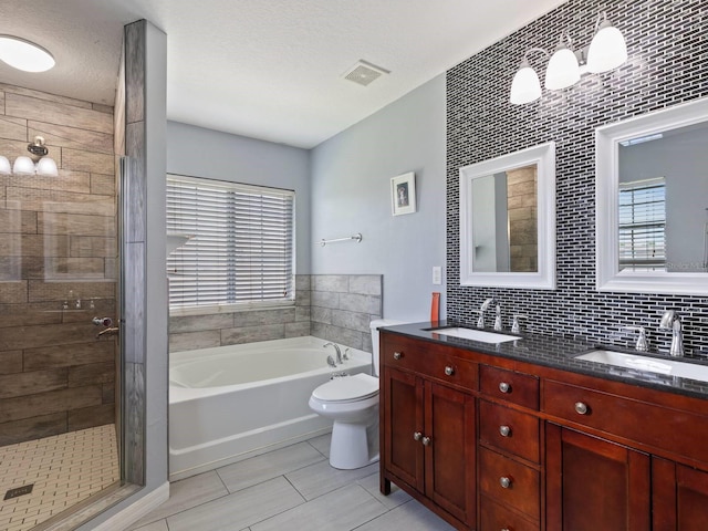 full bathroom featuring backsplash, vanity, a textured ceiling, independent shower and bath, and toilet