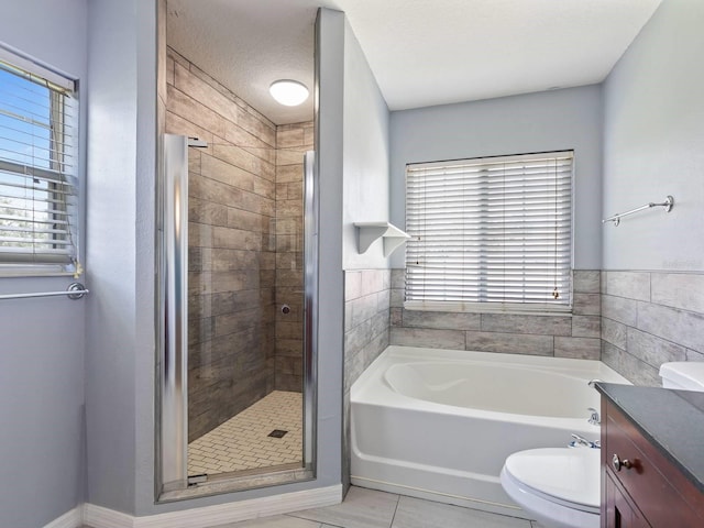 full bathroom with independent shower and bath, tile patterned flooring, vanity, toilet, and a textured ceiling