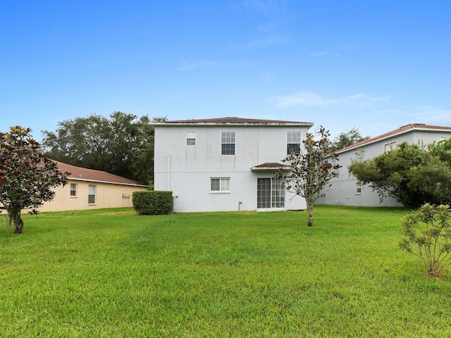 back of house with a yard