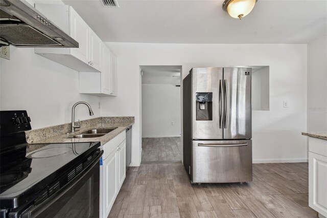 kitchen with exhaust hood, white cabinets, range with electric cooktop, sink, and stainless steel refrigerator with ice dispenser