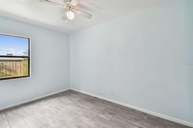 spare room with light hardwood / wood-style flooring and ceiling fan