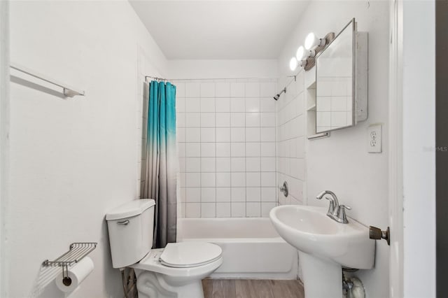 full bathroom with shower / tub combo, hardwood / wood-style flooring, toilet, and sink