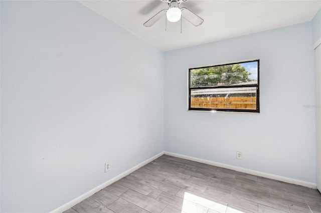 empty room with ceiling fan and light hardwood / wood-style floors