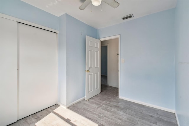 unfurnished bedroom with a closet, ceiling fan, and light hardwood / wood-style flooring