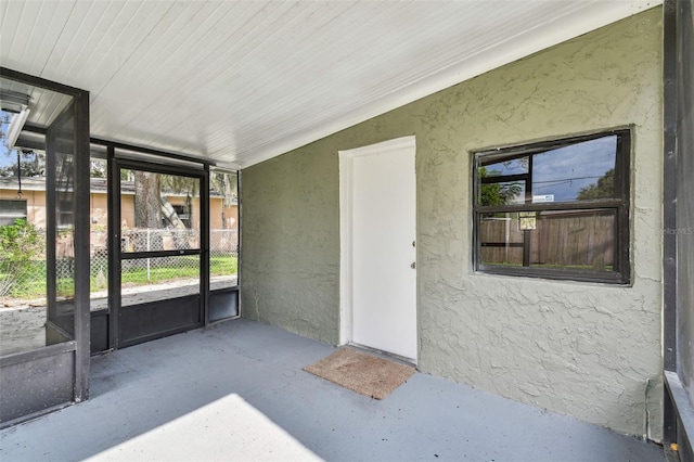 unfurnished sunroom with wood ceiling and vaulted ceiling