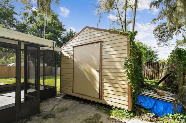 view of outdoor structure featuring a sunroom