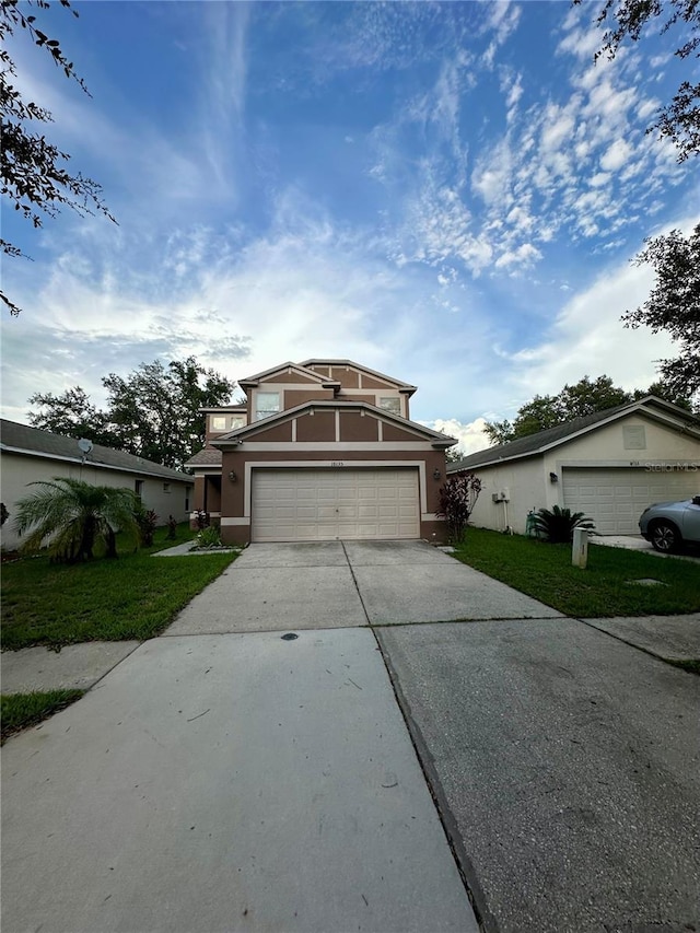 view of front of property with a garage and a front lawn