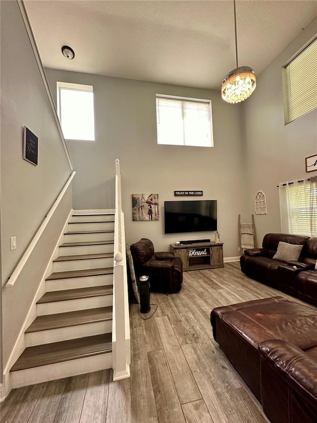 living room featuring hardwood / wood-style flooring, plenty of natural light, and a textured ceiling