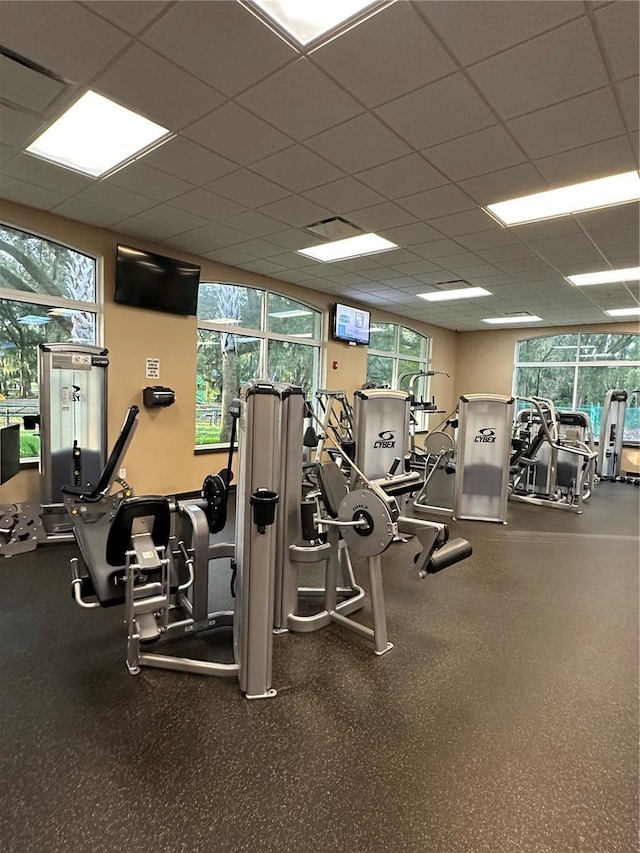 gym with a paneled ceiling