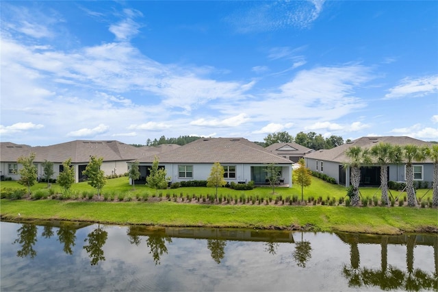 exterior space with a water view and a lawn