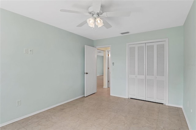 unfurnished bedroom with ceiling fan, a closet, and light tile patterned flooring