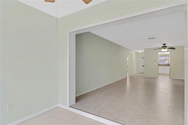 tiled spare room with ceiling fan