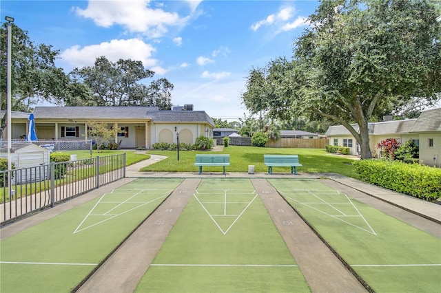 view of property's community featuring a yard