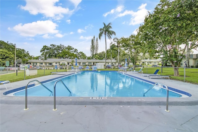 view of pool with a lawn