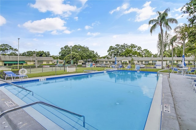 view of pool featuring a yard