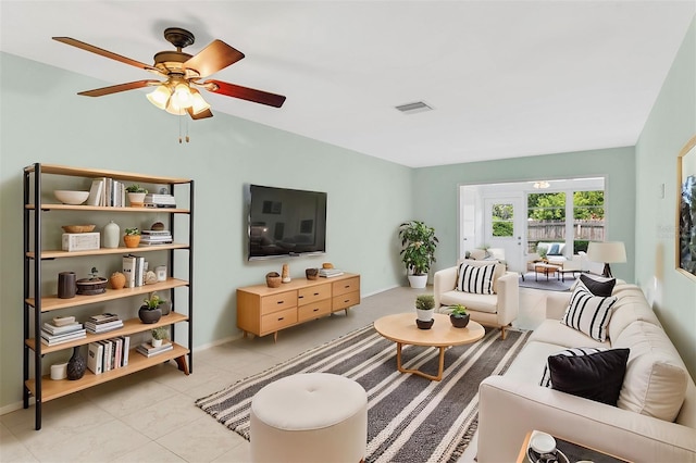 living room with ceiling fan and light tile patterned floors