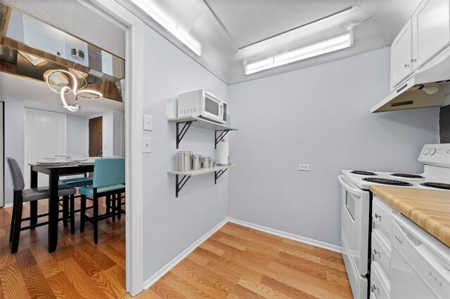 kitchen featuring white cabinetry, light hardwood / wood-style flooring, and white appliances