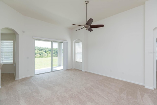 carpeted empty room featuring lofted ceiling and ceiling fan