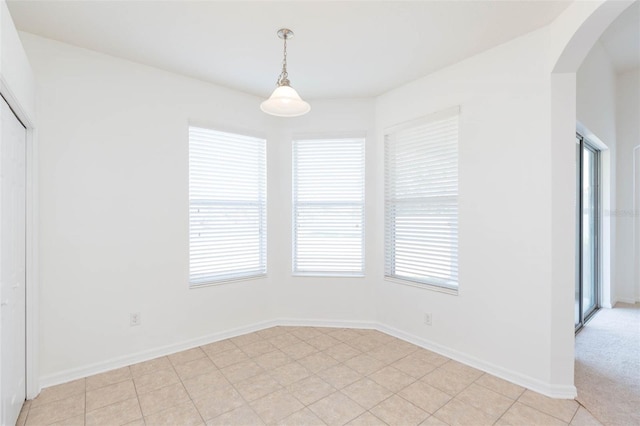 unfurnished dining area featuring light tile patterned flooring