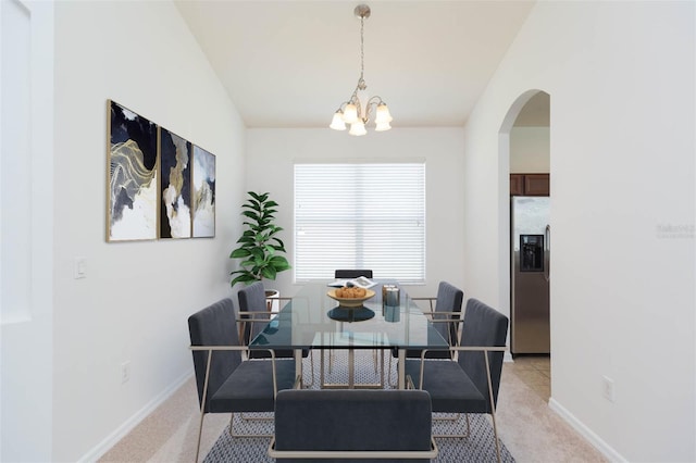 carpeted dining room featuring vaulted ceiling and a notable chandelier