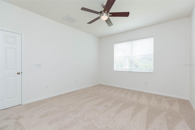 unfurnished room with light colored carpet and ceiling fan