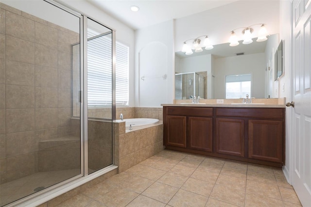 bathroom featuring shower with separate bathtub, plenty of natural light, and tile patterned floors