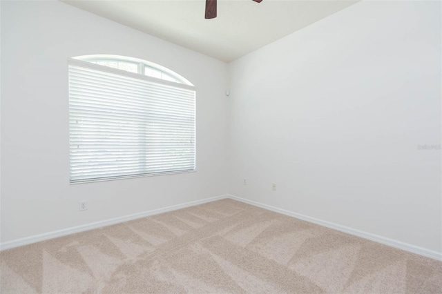 spare room with light carpet and ceiling fan