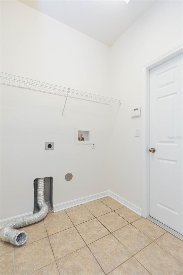 washroom featuring hookup for a washing machine, light tile patterned flooring, and electric dryer hookup