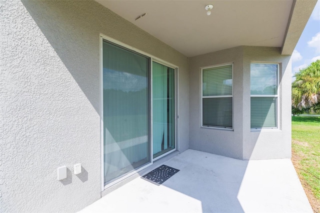 property entrance featuring a patio area