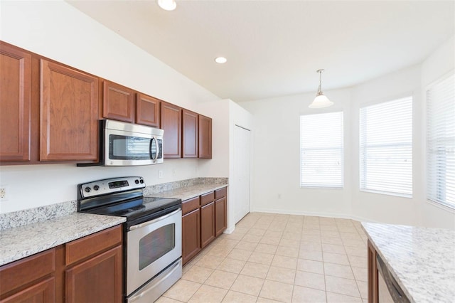 kitchen featuring stainless steel appliances, hanging light fixtures, light tile patterned floors, and light stone counters