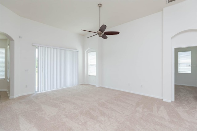 unfurnished room featuring light colored carpet and ceiling fan