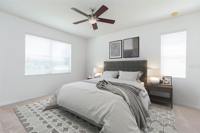 bedroom with ceiling fan and light carpet