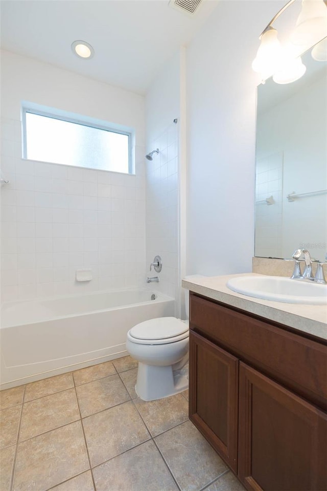 full bathroom with tiled shower / bath, a healthy amount of sunlight, tile patterned floors, and toilet